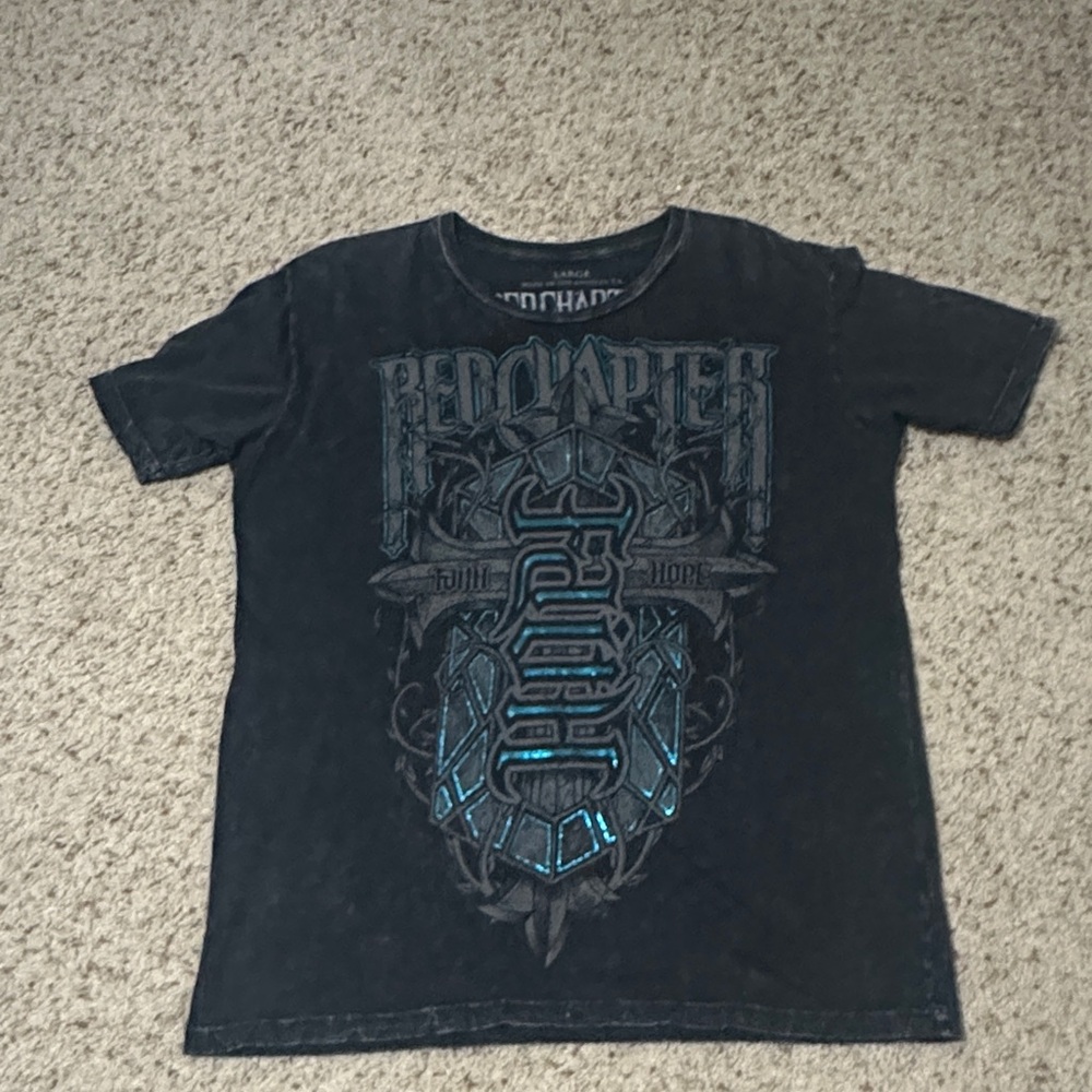 Red Chapter Dark Tee with Blue Graphic.